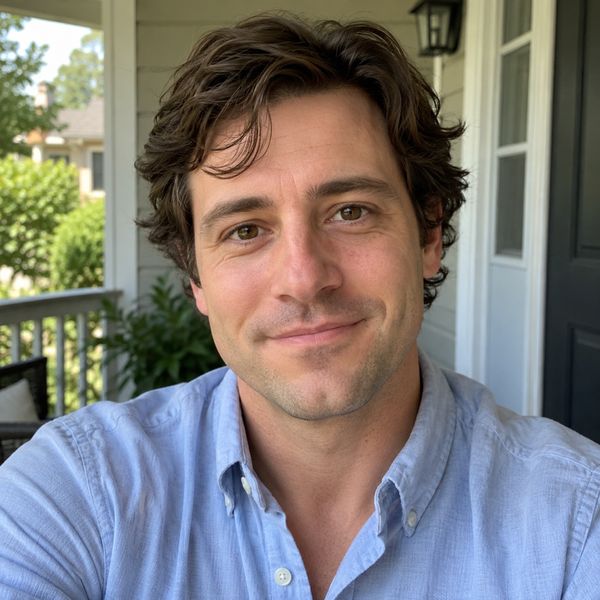 Man in a light blue shirt on a porch